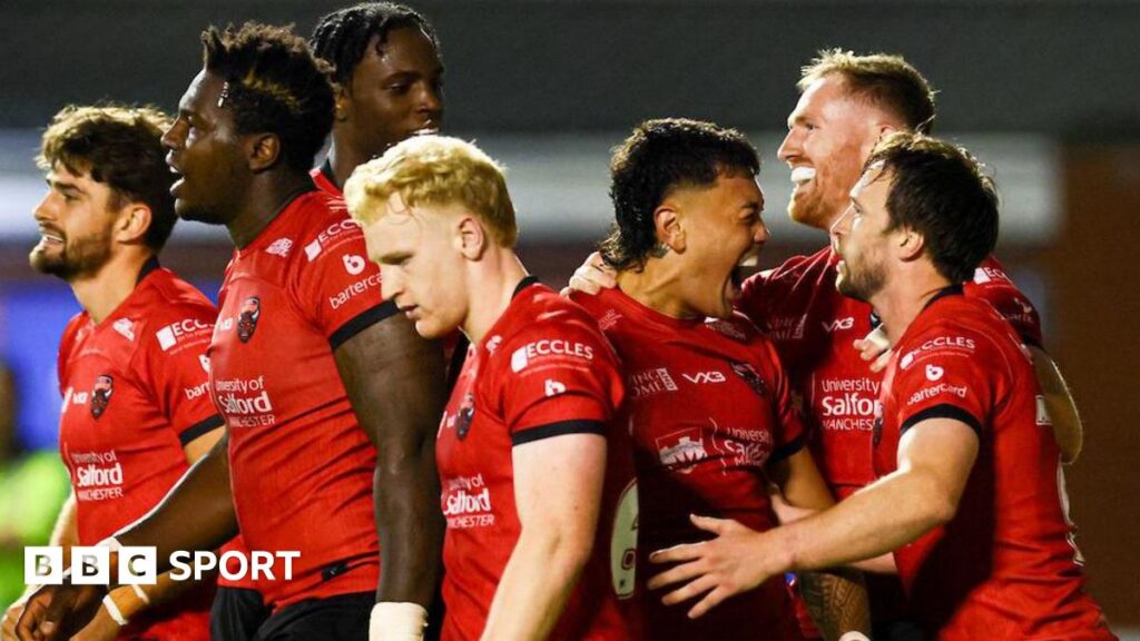 Salford Red Devils players celebrate against Warrington Wolves