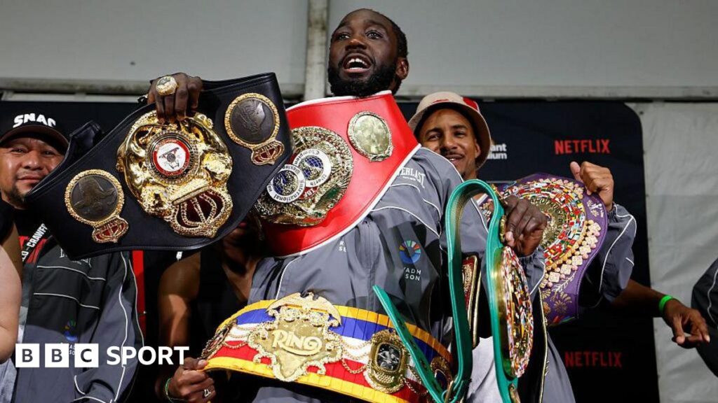 Terence Crawford poses with his new super-middleweight titles