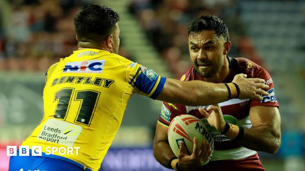 Wigan's Bevan French looks to fend off a tackle against Leeds