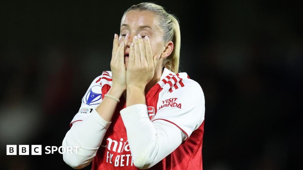 Arsenal striker Alessia Russo holds her hands to her face and looks dejected