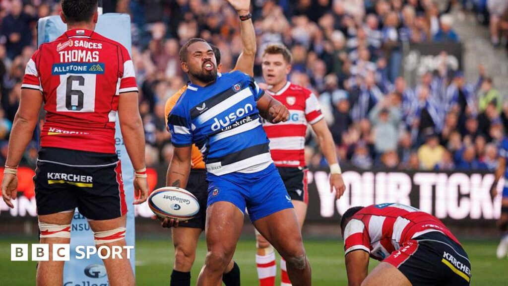 Ollie Lawrence celebrates scoring a try as three Gloucester players look disconsolate in the background