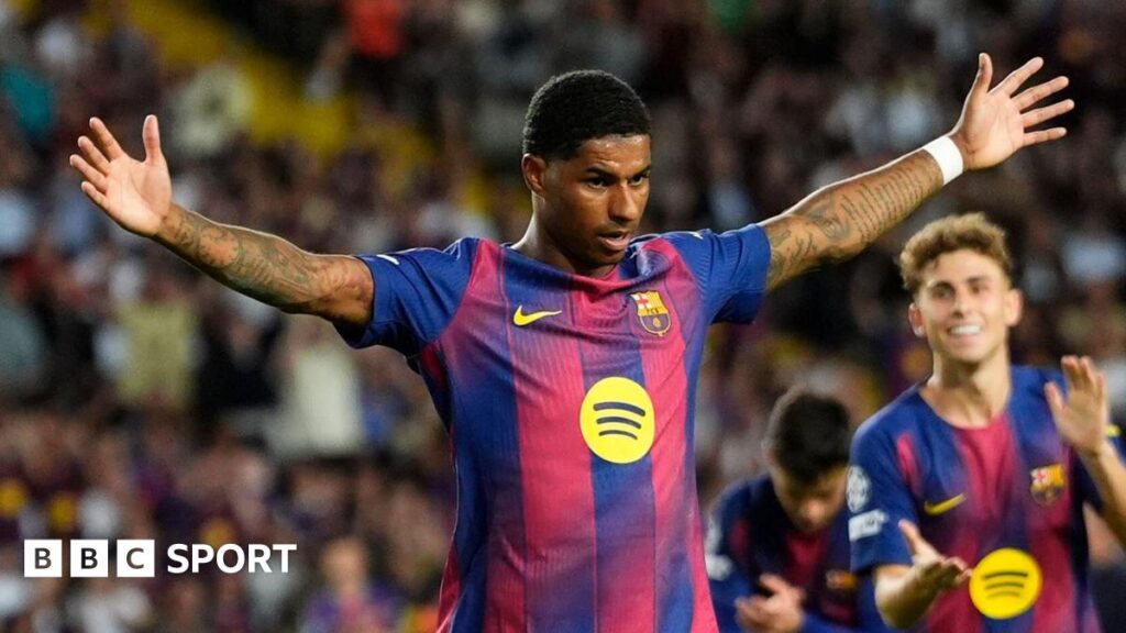 Barcelona striker Marcus Rashford celebrates with his arms spread wide