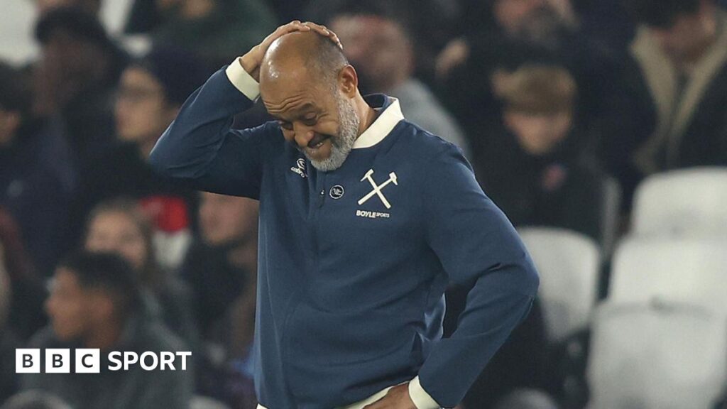 Nuno Espirito Santo looks downwards with his right hand clasped to the top of his head during West Ham's defeat