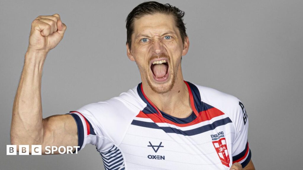 Jack Brown, wearing an England shirt, raises his right first and shouts towards the camera